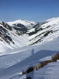 Scenic view of snow covered mountains against sky