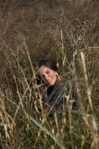 Portrait of young woman standing on field