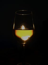 Close-up of light bulb over black background