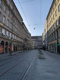 Street amidst buildings against clear sky