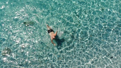 High angle view of man swimming in sea