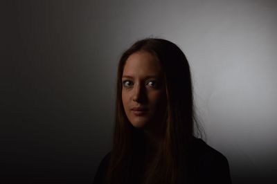 Portrait of young woman against white background