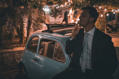 Side view of man using mobile phone