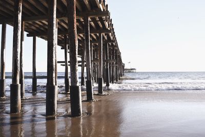 Pier on sea against clear sky