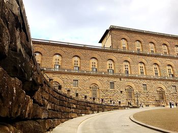 Low angle view of historical building against cloudy sky