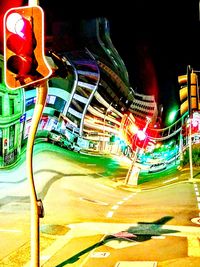 Illuminated ferris wheel in city at night