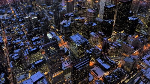 High angle view of city lit up at night