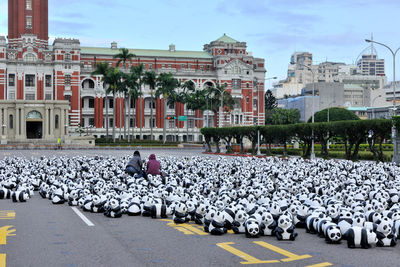 Group of people on road against buildings in city