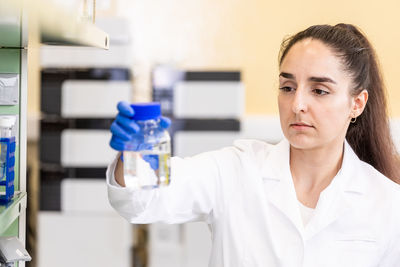 Portrait of young businesswoman working in laboratory