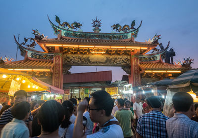 People at illuminated temple