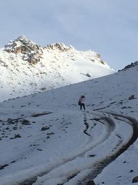 People standing on snow covered mountain