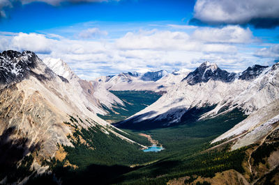 Scenic view of mountains against cloudy sky