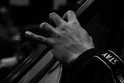 Cropped hand of man playing cello