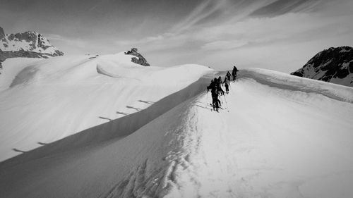 Ski mountaineers climbing snowy mountains