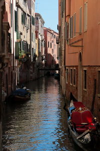 View of canal amidst buildings in city