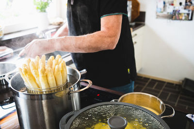 Midsection of man preparing food