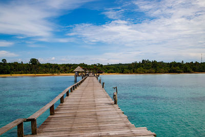 Pier over lake against sky