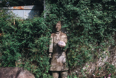 Portrait of statue against trees