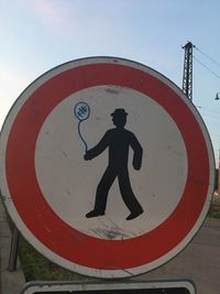 Road sign against sky