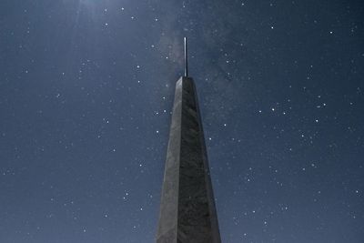 Low angle view of tower against sky at night