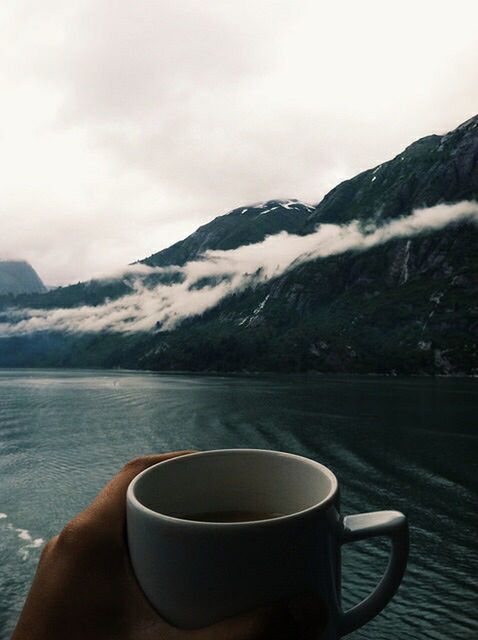 mountain, part of, personal perspective, person, sky, drink, water, food and drink, lifestyles, cropped, leisure activity, refreshment, tranquil scene, unrecognizable person, scenics, holding, mountain range