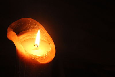 Close-up of illuminated lamp over black background