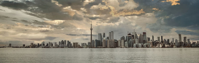 Panoramic view of sea and buildings against sky