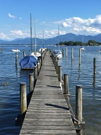 Wooden pier over lake against sky