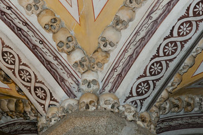 Low angle view of sculptures on ceiling of building