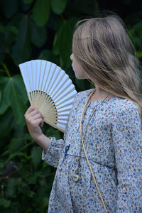 Midsection of woman holding umbrella