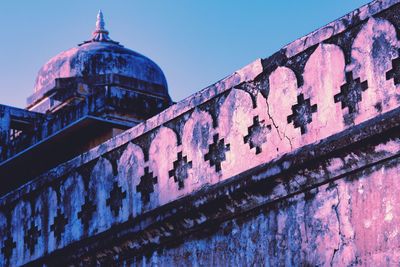 Low angle view of old building against clear blue sky
