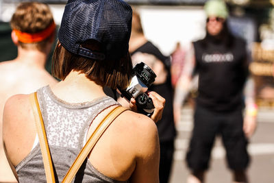 Rear view of people standing outdoors