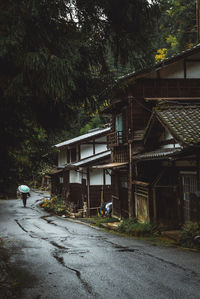 Man walking on street by building