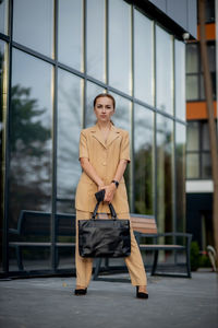 Portrait of young woman sitting on escalator