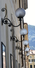 Low angle view of street light against city