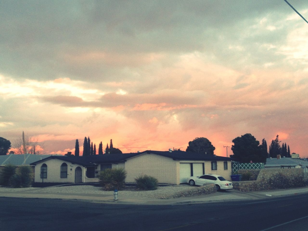 architecture, sky, building exterior, built structure, sunset, cloud - sky, tree, cloudy, cloud, orange color, house, nature, road, beauty in nature, outdoors, no people, weather, silhouette, scenics, dramatic sky