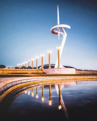 Digital composite image of illuminated tower against blue sky