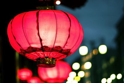 Close-up of illuminated lanterns hanging at night