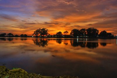 Scenic view of lake against sky at sunset