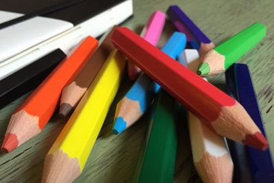 Close-up of multi colored pencils on table