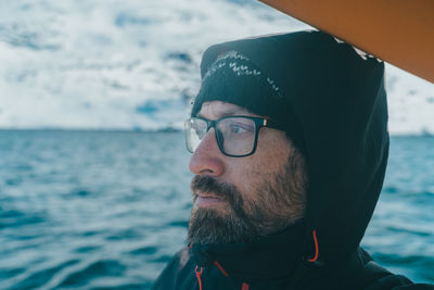 Portrait of handsome explorer looking away at sea