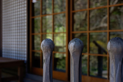 Close-up of wooden bollard against temple