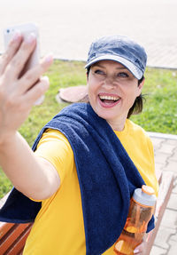 Portrait of a smiling young woman using mobile phone