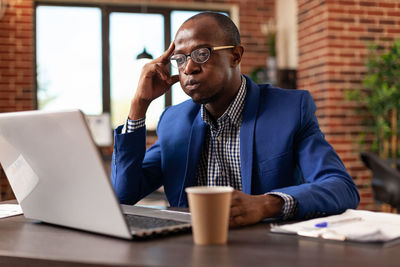 Thoughtful businessman brainstorming at office