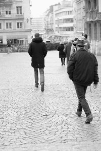 Rear view of people walking on street