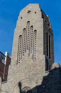 Low angle view of building against blue sky