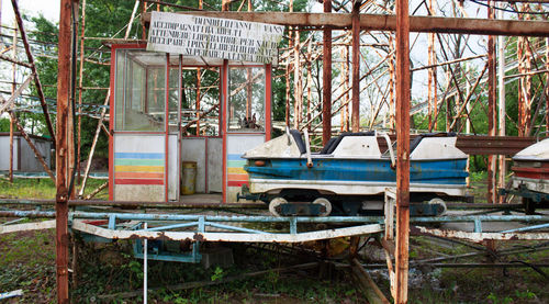 Abandoned shopping cart against trees