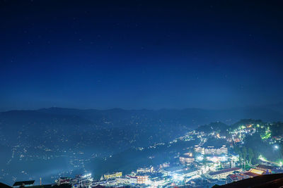 High angle view of illuminated buildings in city at night