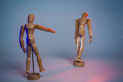 Wooden figurines against gray background