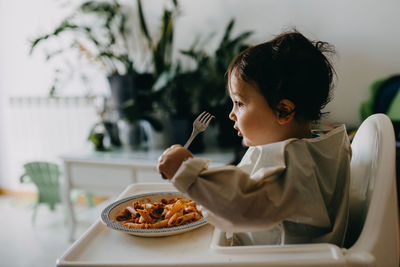 Midsection of woman having food in restaurant